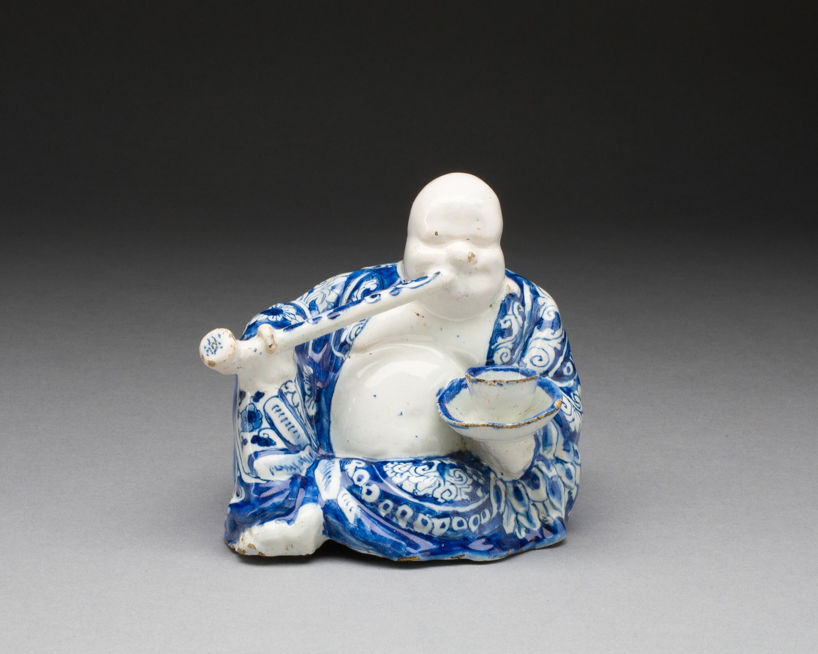 Figure of a Buddhist Monk (Budai Hoshang) — De Grieksche A (The Greek A) Factory; Delft, the Netherlands, 1658-1811