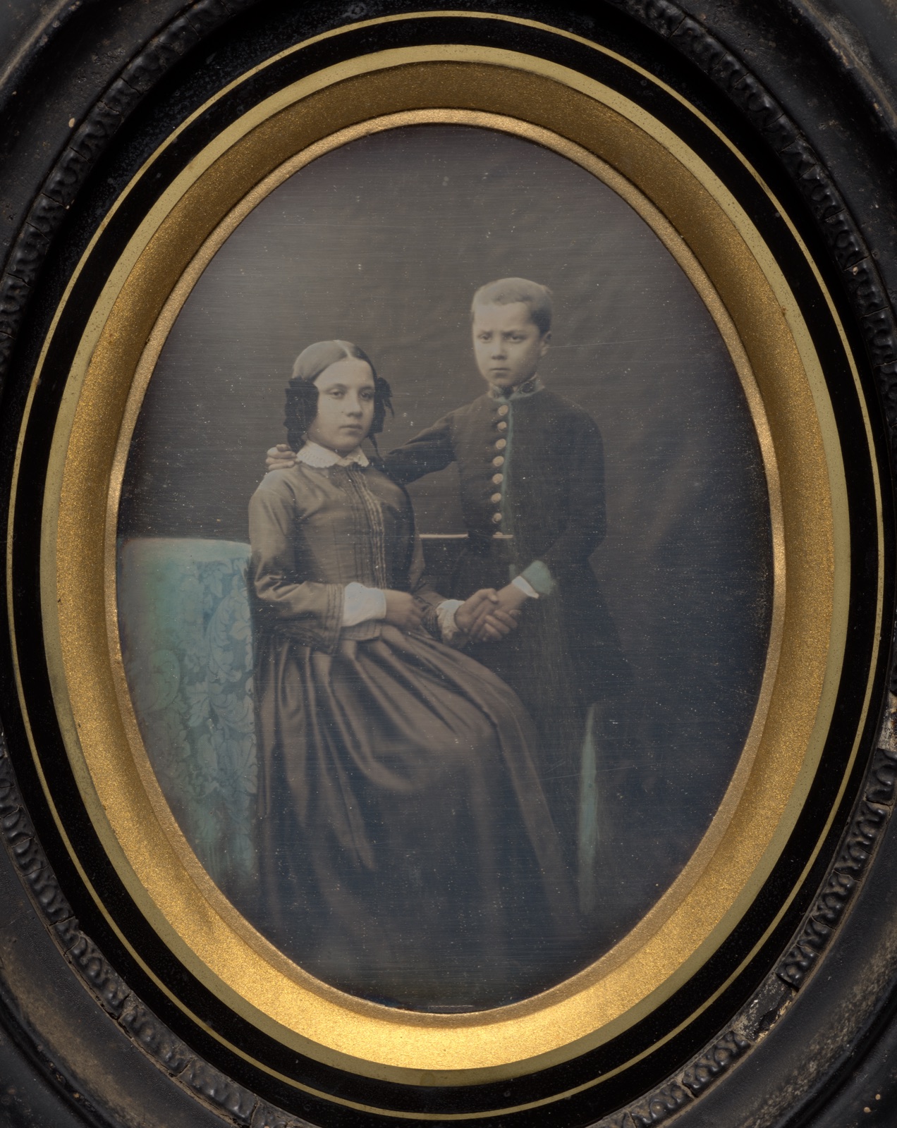 Brother and sister clasping hands