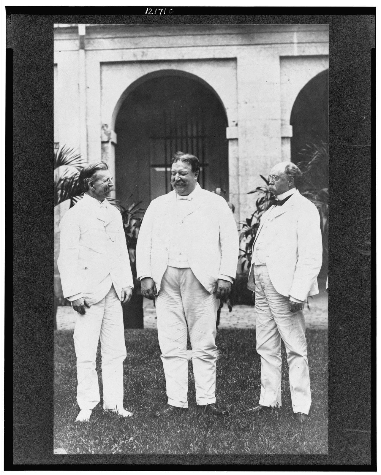 [U.S. Philippine commissioners General Luke E. Wright, William H. Taft, and Judge Henry C. Ide, standing on lawn]