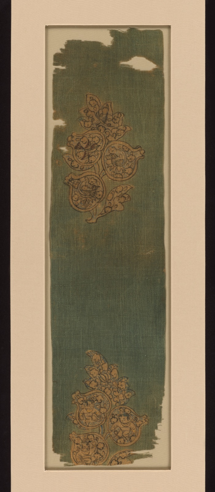 Textile fragment with boys and birds in pomegranates