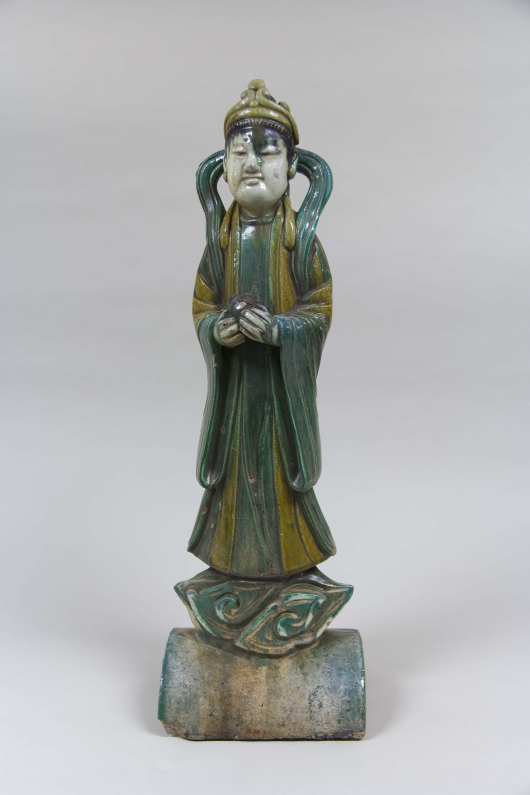 Roof tile with a standing figure