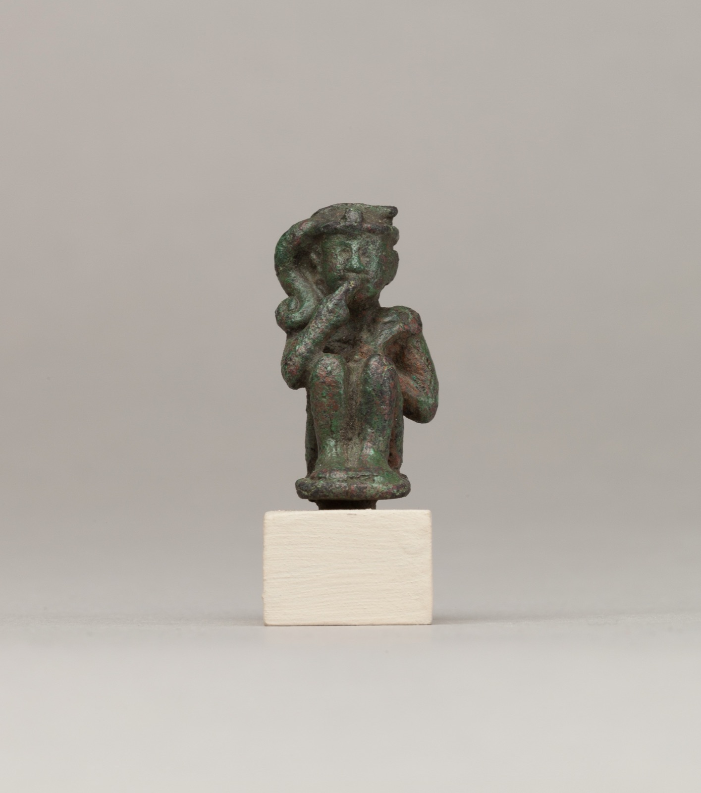 Crouching child god holding scepter