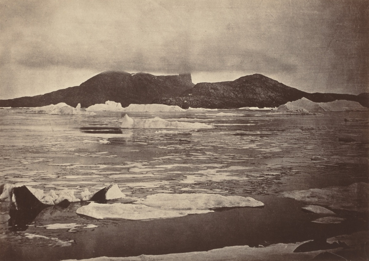 The Arctic Regions: No. 92.* The Devil's Thumb partially enveloped in a fog, with the first of the drift Ice from the pack, which was being forced towards the land, from which we escaped through a narrow lead; had we been hemmed in, we should have had to winter there — John L. Dunmore, and George P. Critcherson