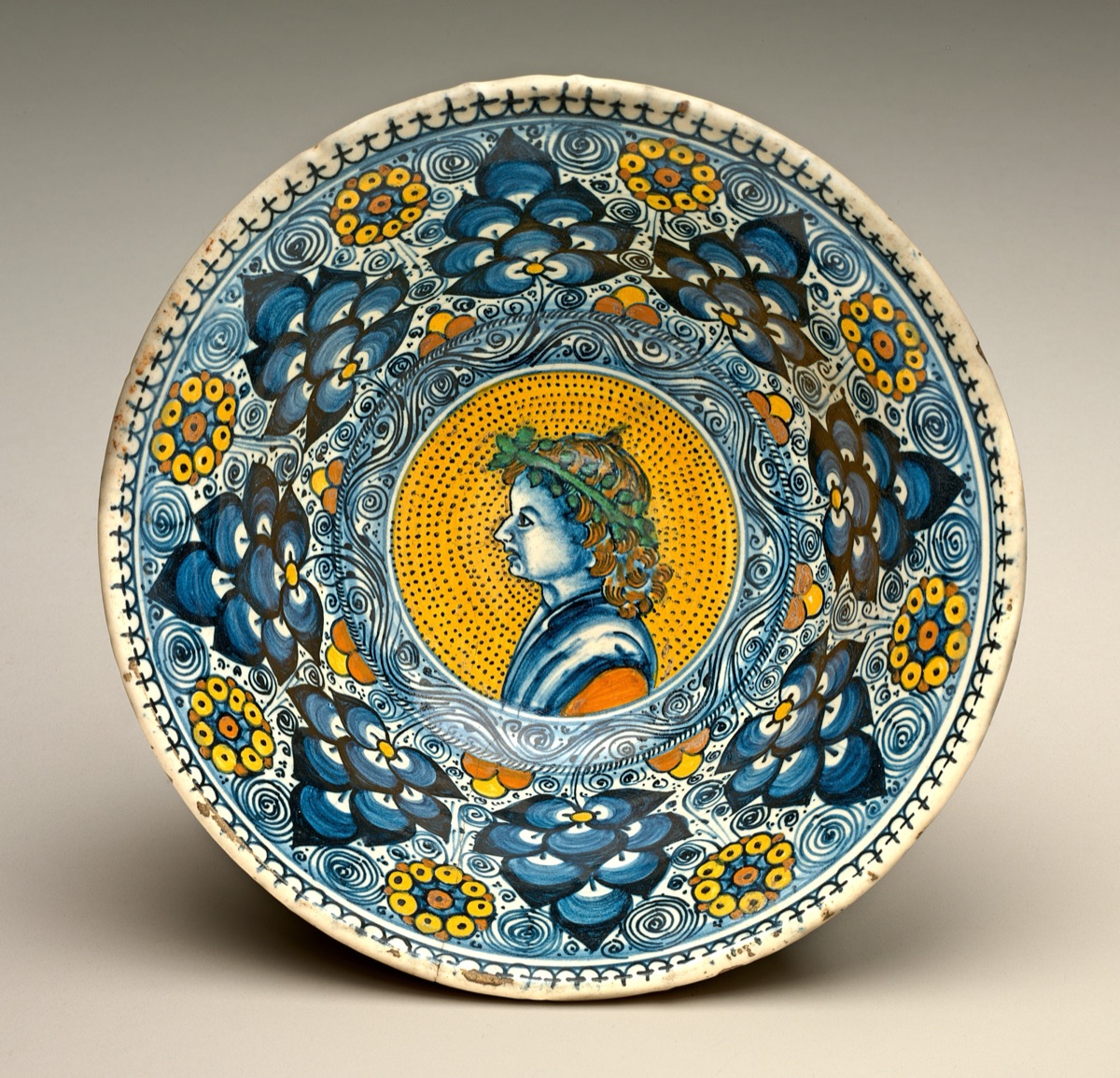 Deep bowl with "Persian palmette" ornament; in the center, a profile bust of a young man wearing a wreath — Tuscan 16th Century; Faenza 16th Century; Probably Tuscany or Faenza 16th Century