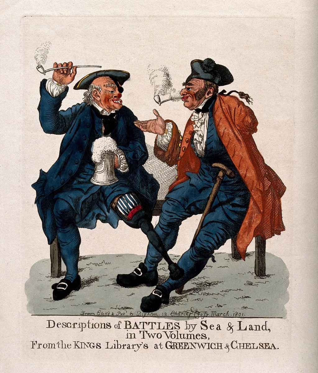 A Greenwich Pensioner sits with a Chelsea Pensioner, telling stories of their campaigns: each is disabled in various ways. Coloured etching by Robert Dighton, 1801. — Robert Dighton